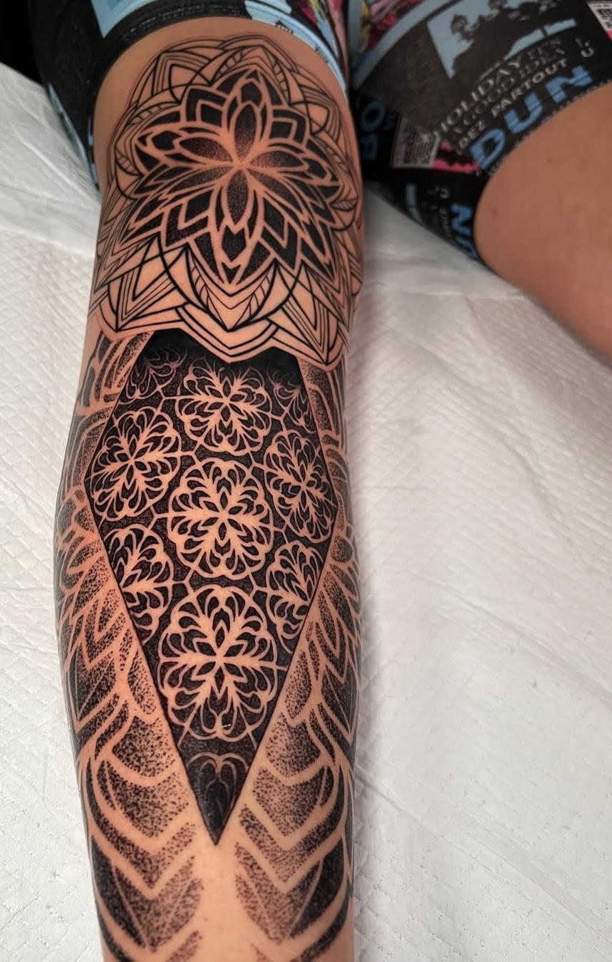 Geometric blackwork double sleeve by Caos Art Tattoo